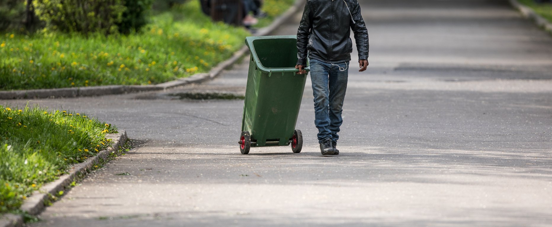 garbage man with trash can cleans up