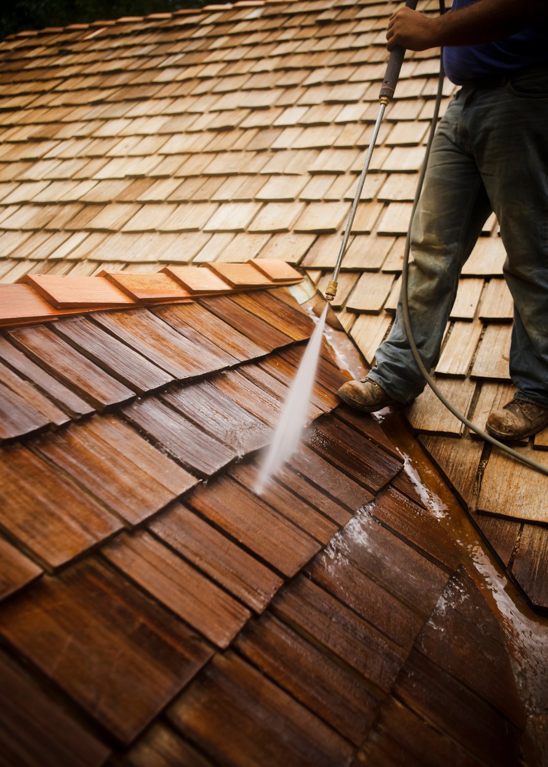 Man Pressure Washing a Roof